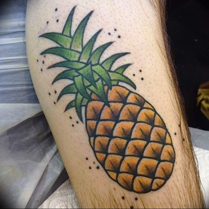 Traditional style pineapple tattoo located on the calf