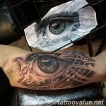 Detailed black and grey tattoo of an eye with musical notes flowing from it, forming a sleeve on the forearm.