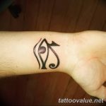 Simple black line art eye tattoo with a stylized design. The tattoo is placed on the wrist, offering a minimalist and elegant aesthetic.