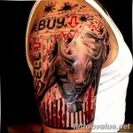 Colorful tattoo sleeve featuring a bull's head amidst stock charts, arrows, and financial symbols, representing a 'bull market' on the upper arm.