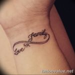 Black ink tattoo on the wrist featuring an infinity symbol with the words 'Love' and 'Family' elegantly scripted within, symbolizing enduring familial love.