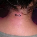 Small black ink infinity symbol tattoo on the back of the neck, minimalist style, delicate design, popular symbol of eternity.