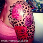Leopard print and pink rose tattoo on the shoulder, colorful realism style, feminine design. A striking tattoo art piece for those who love contrast.