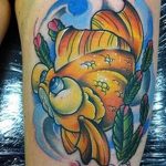 Neo-traditional goldfish tattoo on the upper arm with bold outlines, bright colors, and floral accents, showcasing a dynamic design.