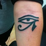 Bold black ink Eye of Horus tattoo on a man's forearm, featuring a traditional Egyptian design and strong linework. A classic tattoo art piece.
