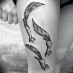 Black ink tattoo featuring three squirrels in mid-leap down the thigh, with flowing tails and detailed shading, creating a sense of movement.