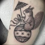 A unique blackwork tattoo featuring a stylized squirrel holding a parasol, with intricate patterns and dotwork shading. The style is illustrative.