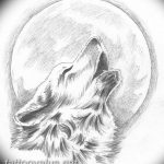 Black and white tattoo resembling a pencil sketch of a howling wolf in front of a full moon, showcasing a soft and artistic style.