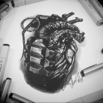 Black and grey realism tattoo sketch of a human heart intertwined with a grenade, showcasing detailed shading and anatomical accuracy.