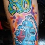 Colorful graffiti-style grenade and lettering tattoo on forearm, vibrant colors, dynamic lines, urban art aesthetic.