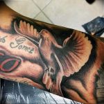 Black and grey realism tattoo of a dove in flight with a name 'Jo Gomez' and the number '50' on the forearm.