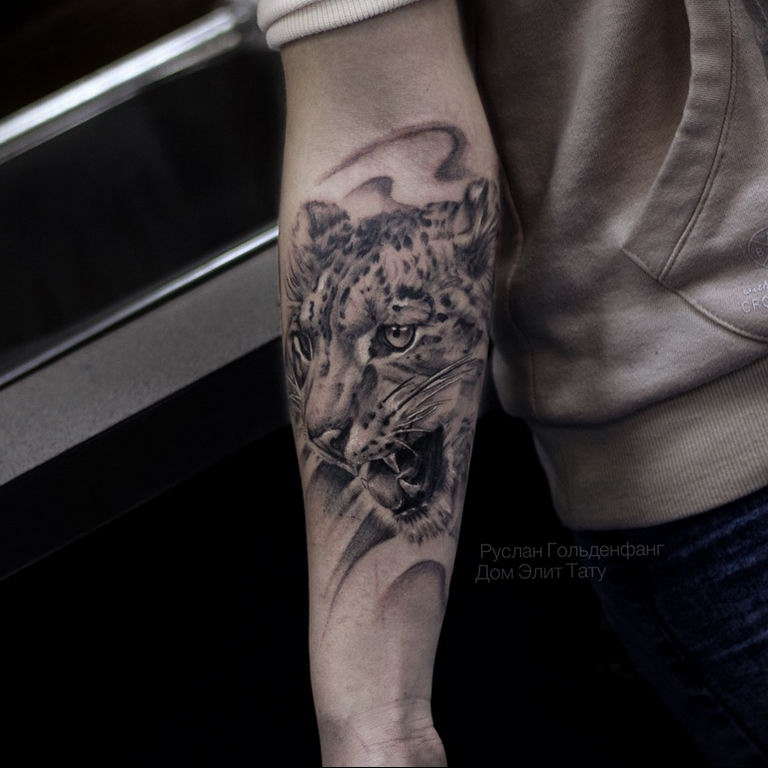 snow leopard tattoo arm