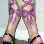 Full leg sleeve tattoo featuring pink bows and ribbon laces wrapping around the legs, showcasing a detailed and eye-catching aesthetic.