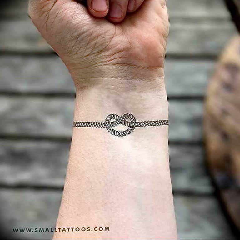 Wrist tattoo of the infinity symbol saying Stay