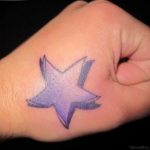 Purple and black star tattoo on the back of a hand, watercolor style, delicate ink ideas, feminine tattoo.