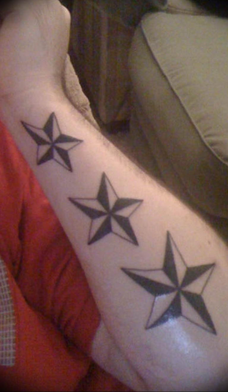 Three tiny stars on the left inner arm