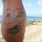 A black ink tattoo on the calf featuring the iconic symbols of Led Zeppelin – a combination of runes representing the band members. A classic rock tribute.