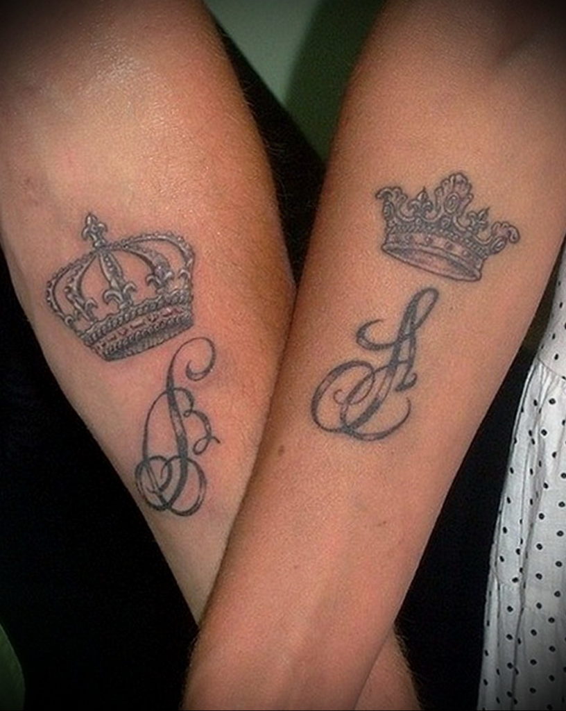 Minimalistic crown and letter J tattooed on the