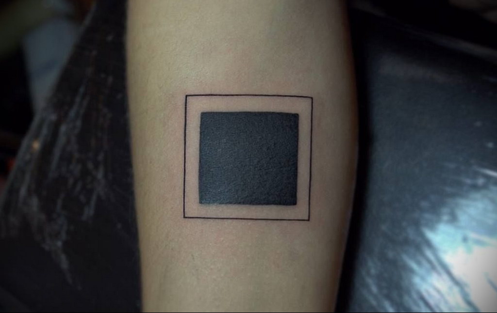 Galactic square tattoo on the back of the left arm