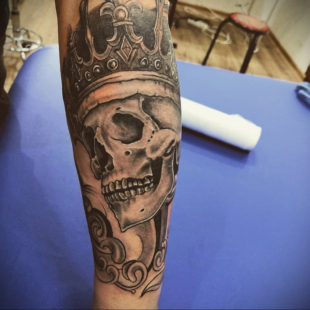 skull wearing crown tattoo