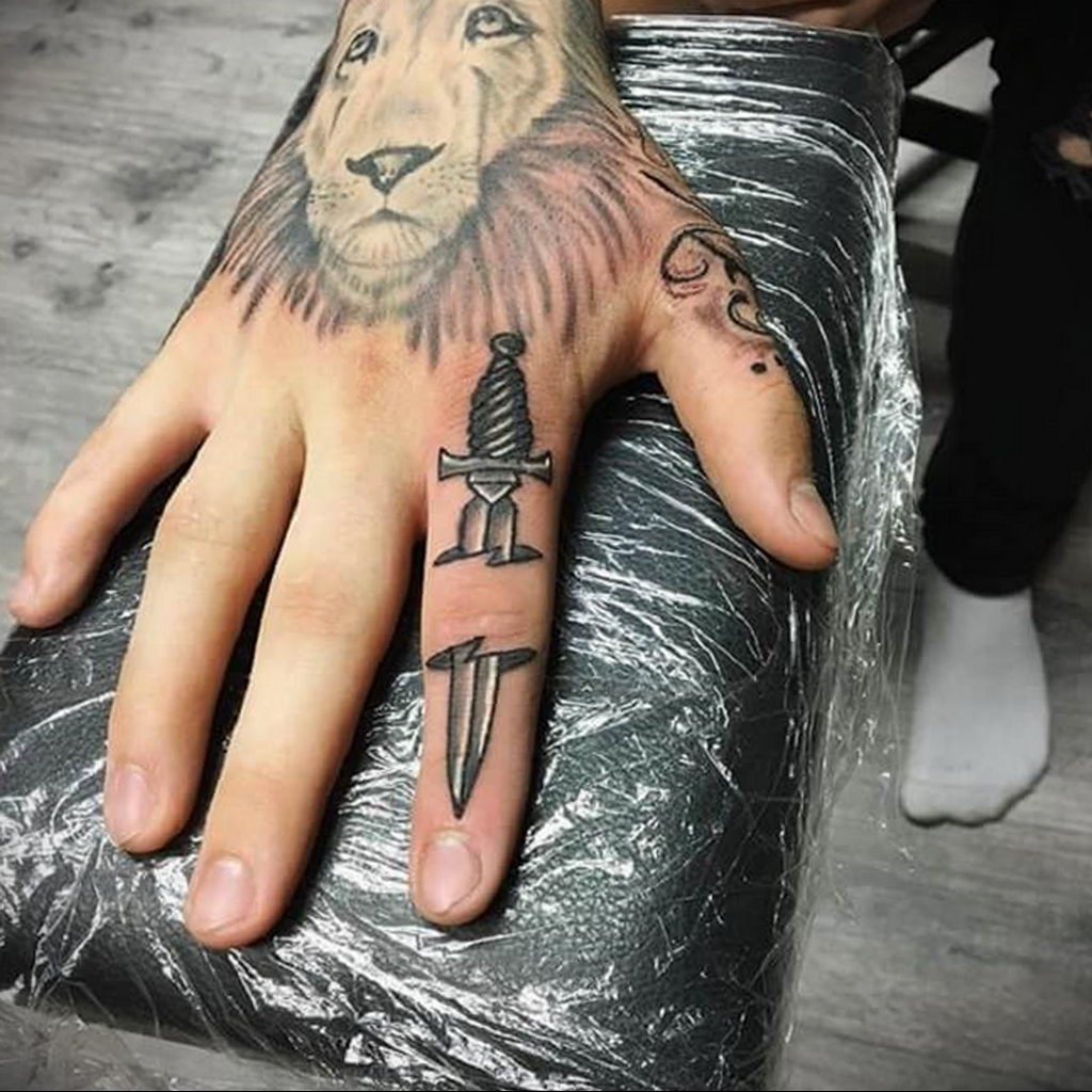 Small Dagger Tattoo On Finger