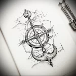 Black and grey sketch of a compass and anchor integrated with a rocky cliff, showcasing a detailed nautical tattoo design.