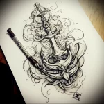 Black and grey tattoo sketch featuring an anchor with a sword crossing it, surrounded by floral elements. Ideal for a back or sleeve tattoo.