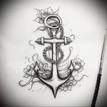 Detailed black and grey anchor tattoo design featuring roses and rope, showcasing a blend of traditional and illustrative styles, suitable for a shoulder or calf.