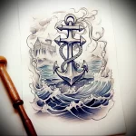 Black and grey tattoo sketch featuring an anchor, lighthouse in the distance, and crashing waves, showcasing a detailed nautical design.