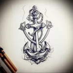 Black and grey tattoo sketch of an anchor with a compass rose and rope detailing, showcasing a traditional nautical style. Suitable for a back or chest piece.