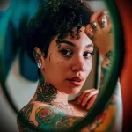 What are the best ink colors for tattoos - A content person looking at their new colorful tatto cbbfb f c cc cc _1 - 030124 tattoovalue.net 030