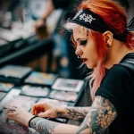 What are the best ink colors for tattoos - A lady looking at tattoo samples to choose the best afb dd e dd bfabacf - 030124 tattoovalue.net 060
