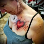What are the best ink colors for tattoos - A lady showing off her vibrant red heart tattoo s ba eb cc aeb - 030124 tattoovalue.net 066