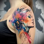 What are the best ink colors for tattoos - A lady with an abstract tattoo featuring splashes of daf a f dbaab - 030124 tattoovalue.net 077