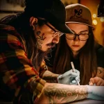 What are the best ink colors for tattoos - A tattoo artist giving a client care instructions fo aead f d dacce - 030124 tattoovalue.net 184