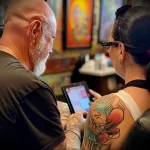 What are the best ink colors for tattoos - A tattoo artist showing a client before and after ph ed ea dfc a aa - 030124 tattoovalue.net 199