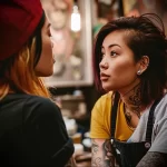 What are the best ink colors for tattoos - A woman discussing her color preferences with a tatt b d c d dcca - 030124 tattoovalue.net 240