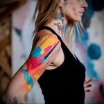 What are the best ink colors for tattoos - A woman with a bright artistic abstract tattoo on he abaabd f cb bacbaa _1 - 030124 tattoovalue.net 269