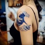 What are the best ink colors for tattoos - A woman with a deep blue ocean wave tattoo style eae de a a dbbccf - 030124 tattoovalue.net 274
