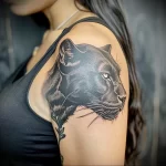 What are the best ink colors for tattoos - A woman with a sleek black panther tattoo style r ca e bc cad _1 - 030124 tattoovalue.net 288