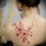 What are the best ink colors for tattoos - A woman with a soft pink floral tattoo style raw be f ef cf - 030124 tattoovalue.net 295