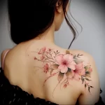 What are the best ink colors for tattoos - A woman with a soft pink floral tattoo style raw be f ef cf _1_2_3 - 030124 tattoovalue.net 298