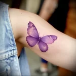 What are the best ink colors for tattoos - An individual with a bright purple butterfly tattoo f dd ad f _1_2 - 030124 tattoovalue.net 326