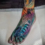 Colorful zebra head tattoo on the foot, featuring a rainbow gradient and striking stripes. A unique and vibrant tattoo design.