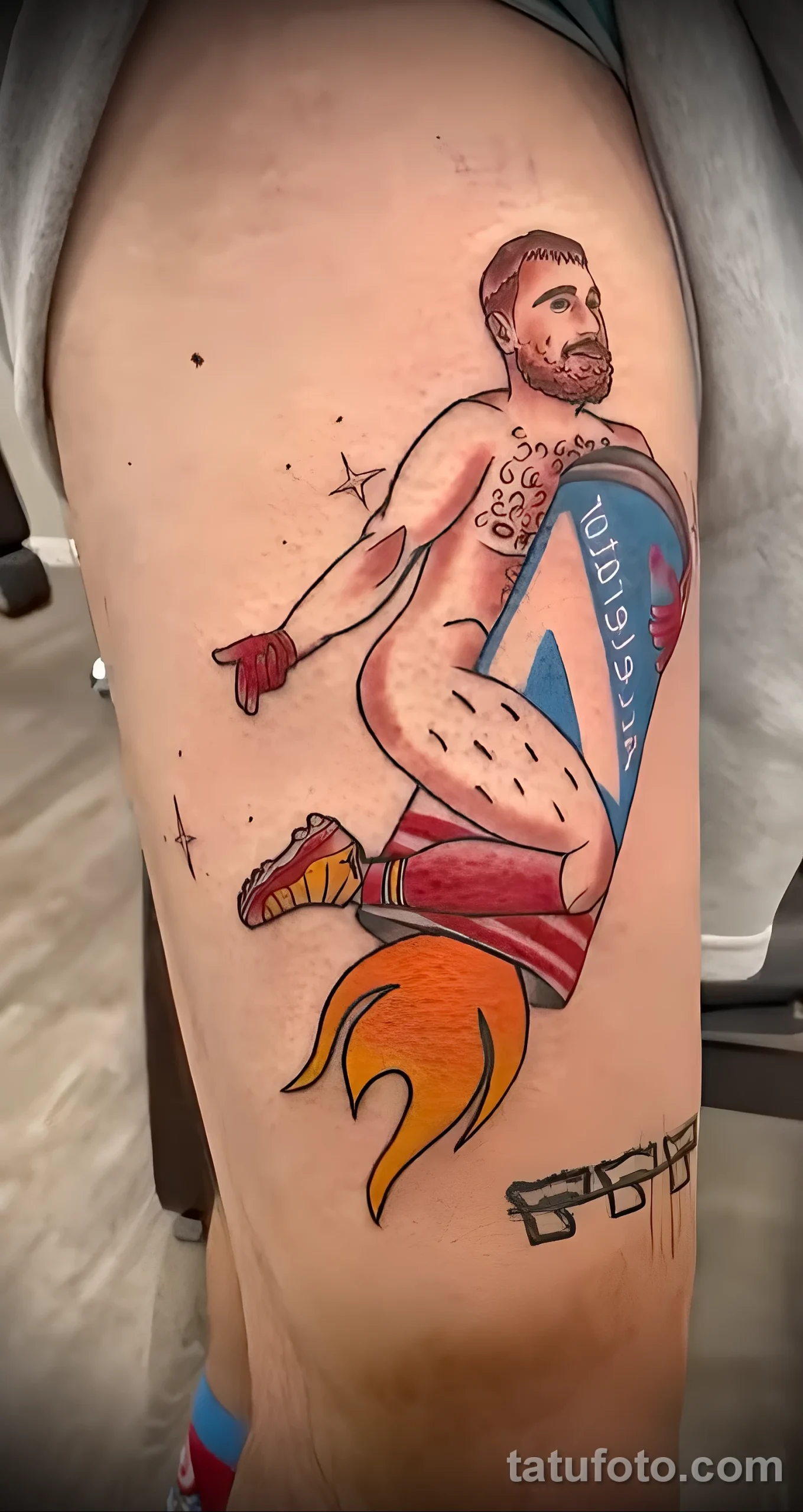 Colorful tattoo of a muscular fighter holding a blue championship belt, with flames and stars, on a side torso. American Traditional style.