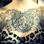 Black and grey tattoo of a cameo portrait surrounded by flowers, birds, and ornate details on the chest. The style is illustrative with a vintage aesthetic.